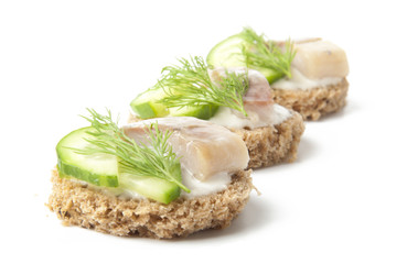 sandwiches with herring, cucumber and dill