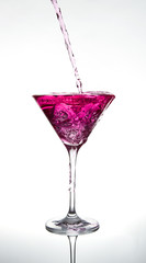 pouring pink cocktail