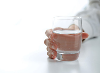 female hand with a glass of water
