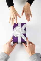 Obraz premium guy giving a girl a valentine gift, top view