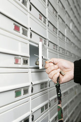 Male hand opening letter box