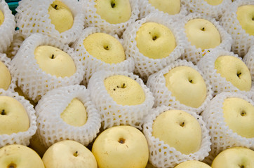 A group of asian pears selling in a market