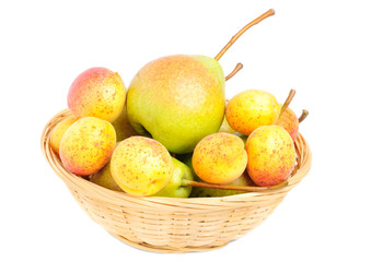 pears and apricots in fruit basket isolated on white background
