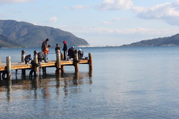 men fishing on a pier