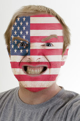 Face of crazy angry man painted in colors of usa flag