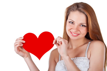 Smiling young woman holding a heart