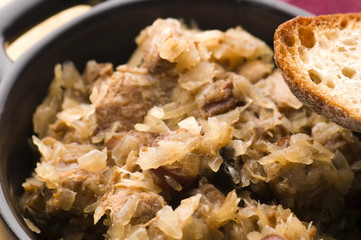 traditional polish sauerkraut (bigos) with mushrooms and plums f