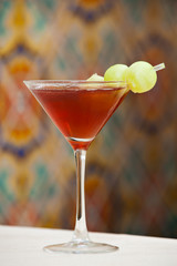 Red Martini Cocktail with melon garnish
