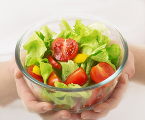 cup of vegetable vegetarian salad in the hands
