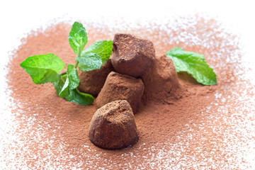 Chocolate truffles with fresh mint dusted with cocoa powder