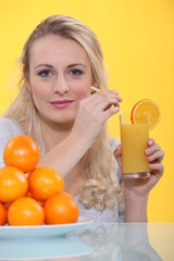 Woman drinking a glass of orange juice