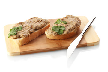 Fresh pate on bread on wooden board isolated on white