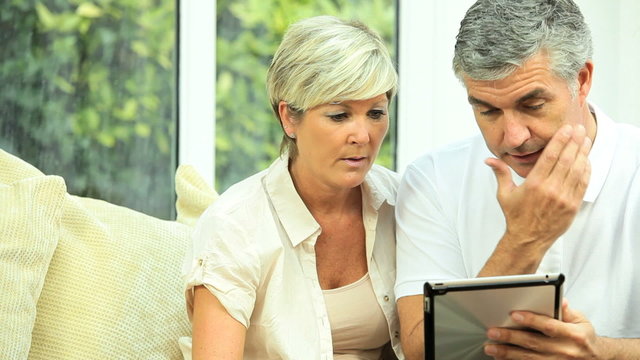 Mature Couple Using Wireless Tablet for Finances