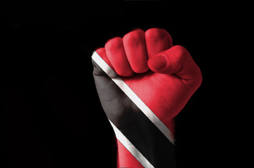 Fist painted in colors of trinidad tobago flag