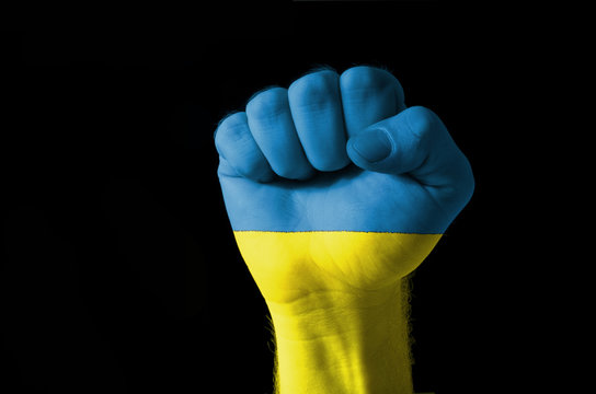 Fist painted in colors of ukraine flag