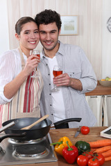 Couple cooking together and drinking wine