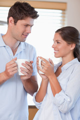 Obraz na płótnie Canvas Portrait of a happy couple drinking coffee
