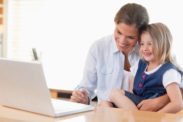 Mother and her daughter using a laptop