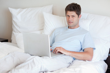 Man lying in bed with notebook