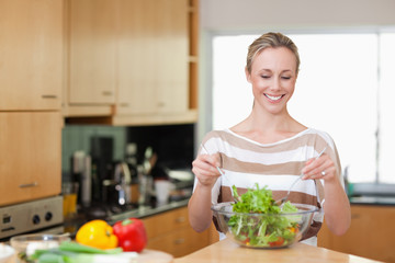 Smiling woman preparing meal