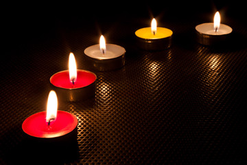 Five candle and flame in dark .