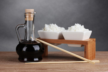 Bowls of cooked rice and soy sauce in jar