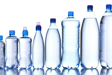 Naklejka premium Group plastic bottles of water isolated on white