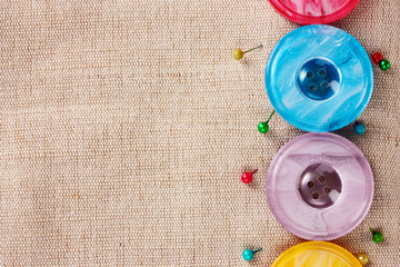 Bright sewing buttons on gray fabric