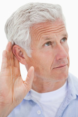 Portrait of a mature man giving his ear