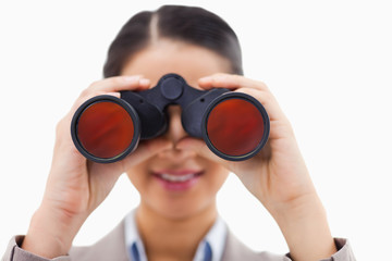 Fototapeta na wymiar Close up of a businesswoman looking through binoculars