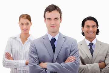 Fototapeta premium Smiling businesspeople with arms folded