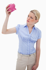 Sad woman with empty piggy bank