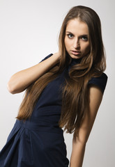 Beautiful fashion model in strict blue dress