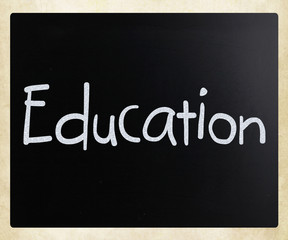 The word "Education" handwritten with white chalk on a blackboar