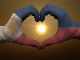 Heart and love gesture by hands colored in phillipines flag duri
