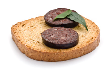 Blood sausage cut into slices on a white background