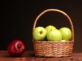 juicy green apples in basket and red apple