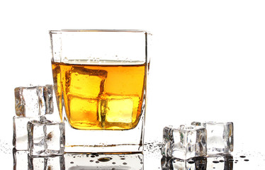 Glass of scotch whiskey and ice isolated on white
