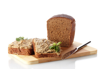 Fresh pate on bread on wooden board isolated on white