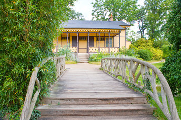 The wooden bridge and the small house in park