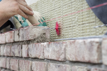 Mason at work building a house