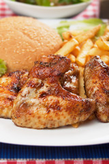 Grilled chicken wings with french fries