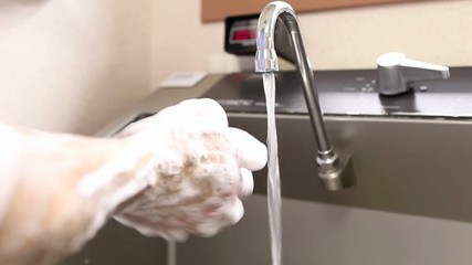 surgeon washing hands - Powered by Adobe