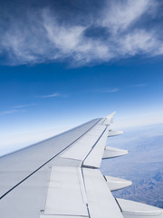 Travel in sky, shot through airplane window