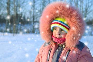 Fototapeta na wymiar Little funny girl walking a winter sunny day.