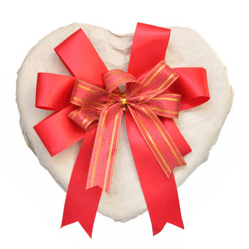 Heart-shaped box with bow on a white background