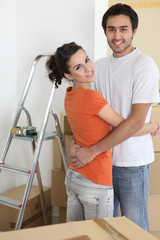 Couple hugging by ladder