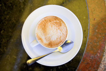 cup of cappuccino on stone table