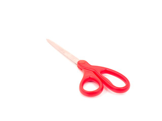 Scissors with red handle on white backgound