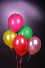 Fototapeta na wymiar bright balloons on purole background